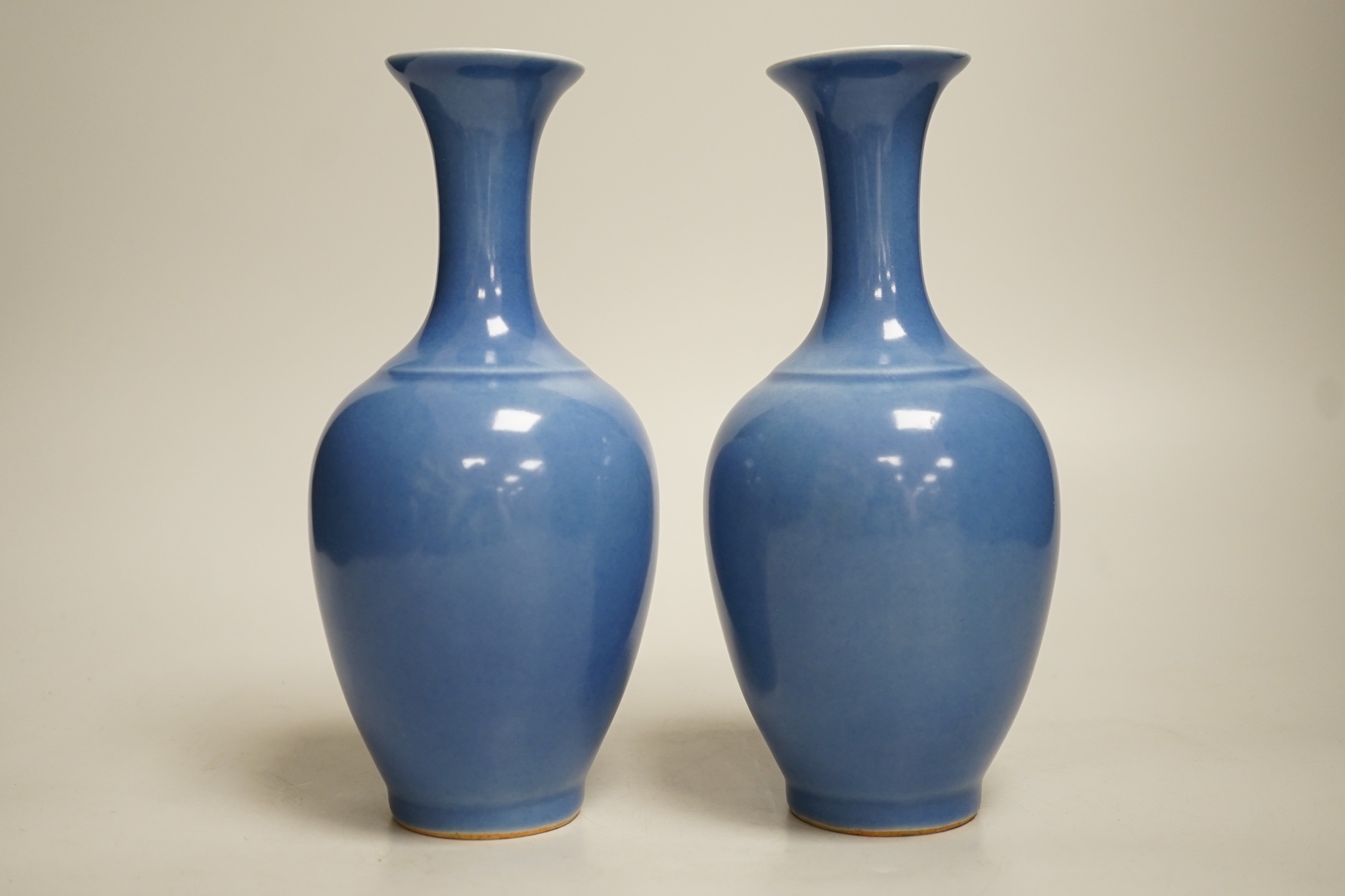 A pair of Chinese blue glazed vases, 21cm